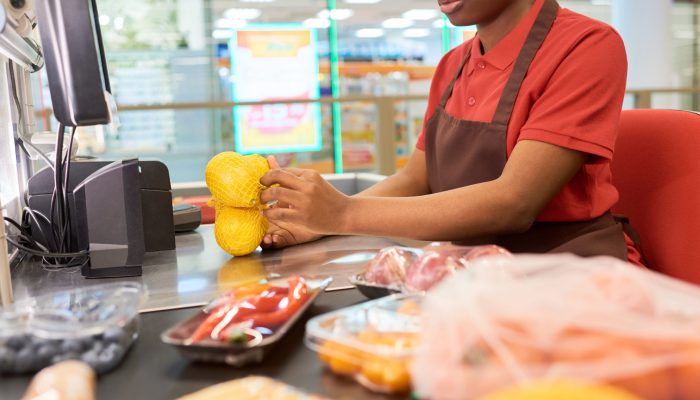 young-african-american-saleswoman-weighing-lemons-2025-03-14-21-13-25-utc.jpg